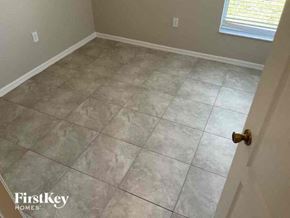 Cape Coral house for rent - A room with a tile floor and a door on the right side.