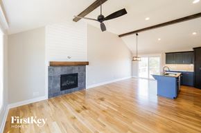 Raymore house for rent - a living room with a fireplace and a hard wood floor