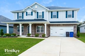 Statesville house for rent - a white house with blue shutters and a white garage door