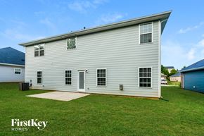 Statesville house for rent - a white house with white siding and a grassy yard
