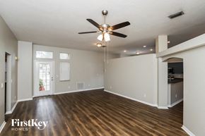 Melbourne house for rent - an empty living room with a ceiling fan