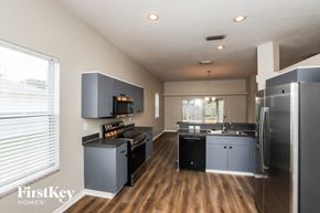 Melbourne house for rent - a kitchen with stainless steel appliances and a large window
