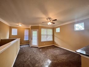 Atlanta apartment for rent - A room with a carpeted floor and a ceiling fan.