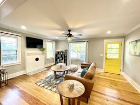 Simpsonville house for rent - a living room with a yellow door and a couch