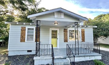 Simpsonville house for rent - a small white house with a yellow door