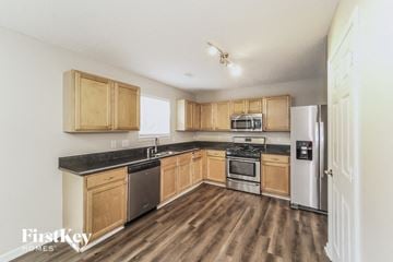 Charlotte house for rent - a kitchen with wooden cabinets and stainless steel appliances
