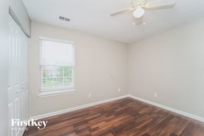 Charlotte house for rent - a living room with wood flooring and a ceiling fan