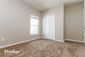 Winter Haven house for rent - a bedroom with carpet and a white door and window
