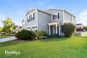 Noblesville house for rent - A house with a well-kept lawn and a white picket fence.