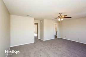 Noblesville house for rent - A spacious room with a ceiling fan and carpeted floor.