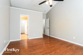 Charlotte house for rent - a living room with wood floors and a ceiling fan