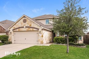 Hockley house for rent - A house with a stone wall and a tree in front.
