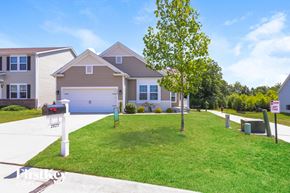 Lake St Louis house for rent - a house with a driveway and lawn in front of it
