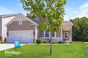 Lake St Louis house for rent - a house with a lawn and a tree in front of it
