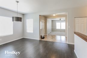 Lake St Louis house for rent - an empty living room and dining room with white walls and wood floors