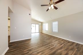 Phoenix house for rent - an empty living room with a ceiling fan