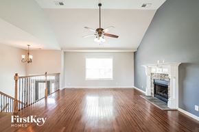 Clarksville house for rent - A spacious living room with a fireplace and a chandelier.