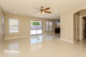 Glendale house for rent - A spacious room with a ceiling fan and a view of the backyard through the sliding glass doors.