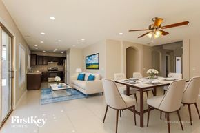 Glendale house for rent - A modern dining room with a glass table and chairs.