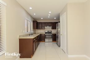 Glendale house for rent - A kitchen with brown cabinets and a white countertop.