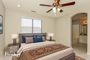 Glendale house for rent - A bedroom with a large bed and a ceiling fan.