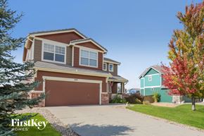 Castle Rock house for rent - a home with a brown and green house and a garage door