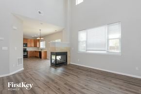 Castle Rock house for rent - the living room and kitchen of an open floor plan with a fireplace