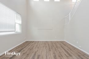 Castle Rock house for rent - the living room of an empty house with wood flooring and a window