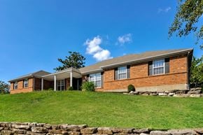 St Louis house for rent - a large brick house on a green hill with grass