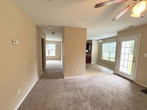 Hope Mills house for rent - A spacious room with a carpeted floor and a ceiling fan.