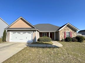 Hope Mills house for rent - a house with a white garage door and a lawn