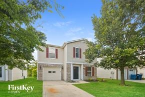 Noblesville house for rent - a house with a sidewalk and trees in front of it
