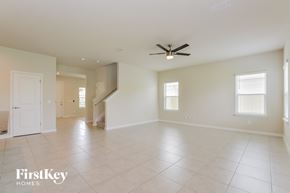 Sanford house for rent - A spacious room with a ceiling fan and tiled flooring.