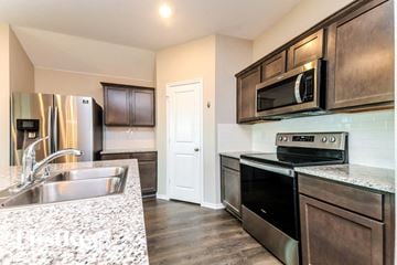 Josephine house for rent - a kitchen with stainless steel appliances and granite counter tops
