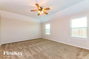 Josephine house for rent - the master bedroom has a carpeted floor and a ceiling fan