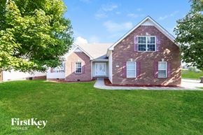Clarksville house for rent - a brick house with a lawn and a white door