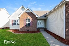Clarksville house for rent - a front view of a house with a sidewalk and grass