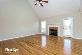Clarksville house for rent - the living room with hardwood floors and a fireplace