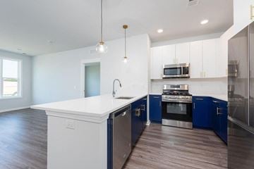 Atlantic Highlands apartment for rent - a kitchen with a white counter top and blue cabinets