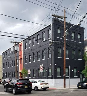 Newark apartment for rent - a city street with cars parked in front of a building