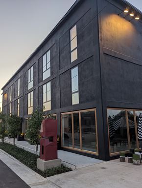 Memphis apartment for rent - A modern building with a dark facade and a red sculpture in front.
