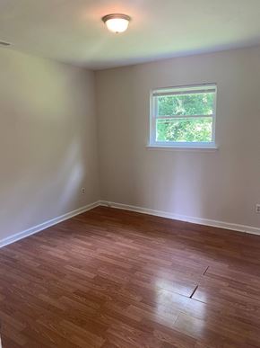 Monroe apartment for rent - an empty room with wooden floors and a window