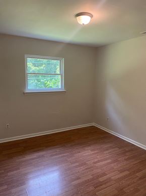 Monroe apartment for rent - an empty room with wooden floors and a window