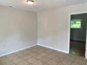 Monroe apartment for rent - an empty living room with a tiled floor and a window