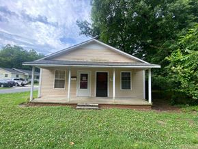 Monroe apartment for rent - a small white house with a porch and a lawn