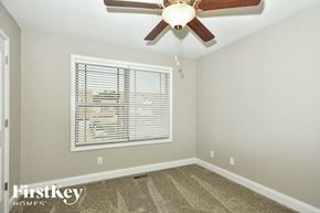 Clarksville house for rent - the master bedroom has a ceiling fan and a large window