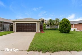 Clearwater house for rent - A house with a brown garage door is for sale.
