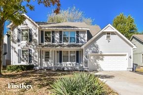 Olathe house for rent - a white house with a white garage and a white