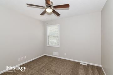 Olathe house for rent - the living room has a ceiling fan and a carpet