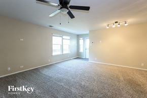 San Antonio house for rent - an empty living room with a ceiling fan and a window